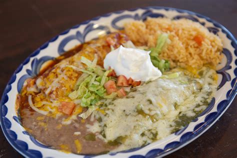 Enchiladas restaurant - Preheat oven to 400 degrees F. Stir together sour cream and 1 cup cheese. Spoon 1/5th of the sour cream mixture into a tortilla. Roll up tortilla and place in a 9×9 inch pan. Repeat until the pan is filled. Pour the enchiladas sauce evenly over the tortillas and sprinkle on the remaining 1 cup cheese.